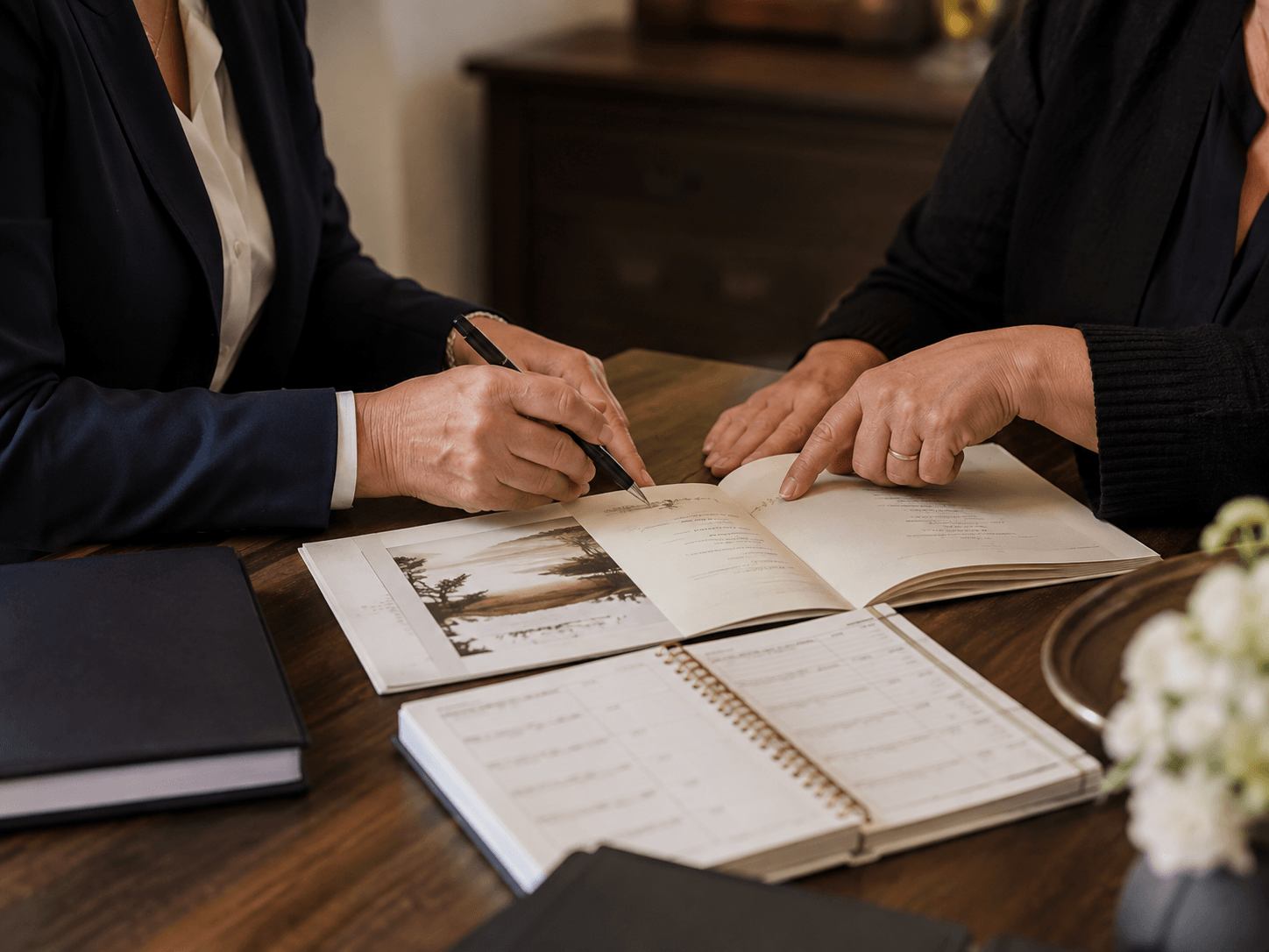 Funeral-home professionals reviewing programme and service-preparation materials